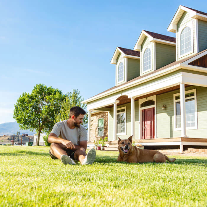 man and his dog enjoying time outdoors on a sunny day